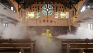 A worker disinfects the Hankou Salvation Church in Wuhan, in China's central Hubei province on March 6, 2020. / AFP / STR

