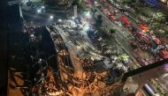 Rescuers search for survivors in the rubble of a collapsed hotel in Quanzhou, in China's eastern Fujian province on March 7, 2020. Around 70 people were trapped after the Xinjia Hotel collapsed on March 7 evening, officials said. / AFP / STR 