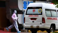  A medical staff member wearing a protective suit walks towards the ambulance near an isolation room at Sulianti Saroso hospital, after indonesia confirmed its first cases of coronavirus disease (COVID-19), in Jakarta, indonesia, March 5, 2020 in this pho