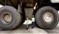 Two Colombian miners inspect a mining truck in the Cerrejon coal mine in Guajira province, May 24, 2007. Reuters/Jose Miguel Gomez