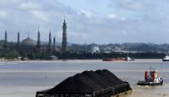 A tug boat pulls a coal barge along the Mahakam River in Samarinda, East Kalimantan province, Indonesia, March 2, 2016. Reuters/Beawiharta