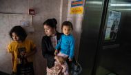 Legal Clinic Myanmar director Hla Hla Yee (C) carrying her daughter before a meeting at the Gender Equality Network office in Yangon February 11, 2020. AFP / Shwe Paw Mya Tin
