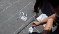 A woman paints the name of a femicide victim for a protest marking International Women's Day, at Zocalo square in Mexico City, Mexico March 8, 2020. Reuters/Ariana Drehsler
 