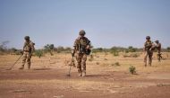 French Army soldiers holds detectors while searching for the presence of Improvised Explosive Devices during the Burkhane Operation in northern Burkina Faso on November 12, 2019. AFP / Michele Cattani