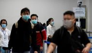 Passengers arriving from Batam, Indonesia, pass a temperature screening station at the Singapore Cruise Center, following the coronavirus outbreak in Singapore March 5, 2020. REUTERS/Edgar Su 