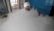 FILE PHOTO: A worker with sanitizing equipment disinfects an office following an outbreak of the coronavirus in the country, in Shanghai, China February 12, 2020. cnsphoto via REUTERS/File Photo 