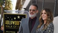 (FILES) In this file photo Tom Hanks and wife Rita Wilson stand before her newly unveiled star after she was honored on the Hollywood Walk of Fame in Hollywood,, California on March 29, 2019.  AFP / Mark RALSTON