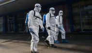  Members of Sofia's Municipality disinfects the biggest market for Chinese goods in Sofia to prevent the spread of the COVID-19, the novel coronavirus, on March 12, 2020. / AFP / NIKOLAY DOYCHINOV