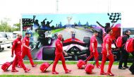 Members of the Ferrari team arrive to pack up their equipment after the Formula One Australian Grand Prix was cancelled in Melbourne on March 13, 2020. AFP / William West 