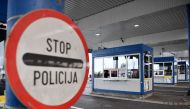 Serbian border police officer wearing a protective mask waits for traveller on March 15, 2020, at the Batrovci border crossing between Serbia and Croatia. AFP / Andrej Isakovic
 
 