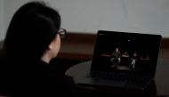 A woman waches the live stream of the performance of the 'First Hungarian Quarantine Theatre' in Budapest, Hungary, March 16, 2020. Picture taken March 16, 2020. REUTERS/Bernadett Szabo