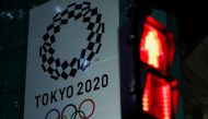 FILE PHOTO : A banner for the upcoming Tokyo 2020 Olympics is seen through a traffic signal in Tokyo, Japan, March 11, 2020. REUTERS/Issei Kato/File Photo
