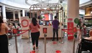 People visit a food court with social distancing markers on the floor at a shopping mall, amid concerns over the spread of the COVID-19 coronavirus, in Bangkok on March 20, 2020. / AFP / Lillian SUWANRUMPHA
