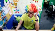 A Filipino online tutor wears a wig as he talks to students from a computer in the head office of 51Talk, as the spread of the coronavirus disease (COVID-19) continues, in Pasig City, Metro Manila, Philippines March 12, 2020. Picture taken March 12, 2020.