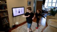 Alice and Joseph Wilkinson take part in a YouTube P.E. class at their home in Manchester, as the spread of the coronavirus disease (COVID-19) continues, in Manchester, Britain, March 23, 2020. REUTERS/Phil Noble