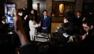 Japan's Prime Minister Shinzo Abe speaks to the press in front of the prime minister's residence in Tokyo on March 24, 2020.   AFP / CHARLY TRIBALLEAU
