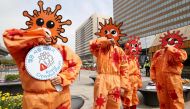 Members of the Asian Citizen's Center for Environment and Health wearing masks depicting the coronavirus perform during a campaign for preventative measures against the COVID-19 coronavirus, in Seoul on March 26, 2020./ AFP / YONHAP / 