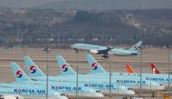 Korean Air's passenger planes are parked on the tarmac as overseas flight routes are reduced following the outbreak of coronavirus disease (COVID-19), at Incheon International Airport in Incheon, South Korea, March 24, 2020. REUTERS/Heo Ran/File Photo