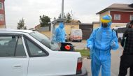 Units disinfect a vehicle in the Uzbek capital Tashkent at a checkpoint, built to control vehicles within the measures taken against the coronavirus (Covid-19) pandemic on March 24, 2020.  Bahtiyar Abdülkerimov - Anadolu
