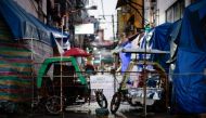 FILE PHOTO: Rickshaws block a street from outsiders to protect a neighborhood from the spread of the coronavirus disease (COVID-19) in Manila, Philippines, March 24, 2020. REUTERS/Eloisa Lopez/File Photo