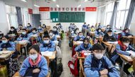 Students sit in a classroom as grade three students in middle school and high school return after the term opening was delayed due to the COVID-19 coronavirus outbreak, in Huaian in China's eastern Jiangsu province on March 30, 2020. / AFP / STR