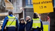 Dutch policemen carry out contols in order to check if people follow the measures put in place in Amsterdam, The Netherlands, on March 31, 2020, amid the outbreak of COVID-19 (novel coronavirus). Netherlands OUT / AFP / ANP / Koen Van Weel