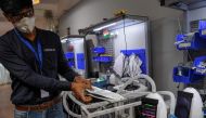 In this photo taken on March 25, 2020, AgVa Healthcare employee Vaibhav Gupta demonstrates using a ventilator at the research and development (R&D) centre in Noida in Uttar Pradesh state. AFP / Prakash Singh  
