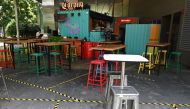 Tape to mark off spaces for social distancing are seen on the floor of a restaurant in Marina Bay in Singapore on April 2, 2020, as the government slowly tightens restrictions to combat the spread of the COVID-19 novel coronavirus. / AFP / Roslan RAHMAN