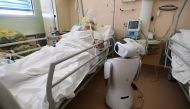 One of the six robots of the Circolo di Varese hospital stands near a patient, on April 3, 2020, to help the healthcare staff of the High Intensity Medicine department to assist twelve patients suffuring from the epidemic Covid-19, caused by the novel cor