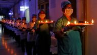 Staff members of a hospital carry candles and oil lamps to show solidarity with people who are affected by the coronavirus disease (COVID-19), and with doctors, nurses and other healthcare workers from all over the world during a 21-day nationwide lockdow
