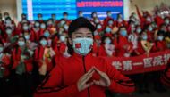 A medical staff member from Jilin Province tears up during a ceremony before leaving as Tianhe Airport is reopened in Wuhan in China's central Hubei province on April 8, 2020. / AFP / Hector RETAMAL