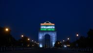 India gate is illuminated with the colors of the Indian national flag as seen from a deserted Rajpath during a government-imposed nationwide lockdown as a preventive measure against the COVID-19 coronavirus a in New Delhi on April 8, 2020. / AFP / Sajjad 