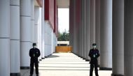 Security personnel stand outside a field hospital that had offered beds for COVID-19 coronavirus patients during the height of the crisis in Wuhan in China’s central Hubei province on April 9, 2020. AFP / Noel Celis