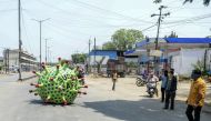 People stop to watch as inventor Sudhakar Yadav (inside) leads his coronavirus-themed made car on a road for an awareness campaign during a government-imposed nationwide lockdown as a preventive measure against the COVID-19 coronavirus, in Hyderabad on Ap