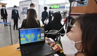 A thermal camera system monitors the body temperature of people during early voting at a polling station in Seoul on April 10, 2020, ahead of next week's parliamentary elections. AFP / Jung Yeon-je