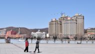 People wearing face masks are seen at a park in Suifenhe, a city of Heilongjiang province on the border with Russia, as the spread of the novel coronavirus disease (COVID-19) continues in the country, China April 12, 2020. REUTERS/Huizhong Wu