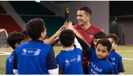 Australian legend and SC Global Ambassador Tim Cahill shares a light moment with young players during a training session in Doha as part of the Generation Amazing programme.