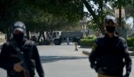 Policemen stand guard after cordoning an area during a government-imposed nationwide lockdown as a preventive measure against the COVID-19 coronavirus, in Karachi on April 12, 2020. / AFP / Rizwan TABASSUM