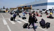 Romanians, hoping to travel to Germany, wait on the parking in front of 