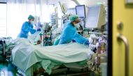 :TOPSHOT - Medical staff take care of a Covid-19 patient in an intensive care unit at the University hospital of Aachen, western Germany, on April 15, 2020 during the novel coronavirus COVID-19 pandemic. / AFP / Ina FASSBENDER
