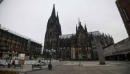 A police car is seen on the almost empty square in front of the Cologne cathedral in Cologne, western Germany, on April 19, 2020, amid the novel coronavirus COVID-19 pandemic. / AFP / Ina FASSBENDER