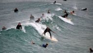 People surf at Maroubra Beach in Sydney on April 20, 2020. Authorities in Sydney reopened three beaches for walking, running, swimming or surfing only amid lockdown restrictions put in place due to the COVID-19 coronavirus outbreak. / AFP / Saeed KHAN
