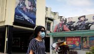 A woman, wearing a protective face mask, walks past Ministry of National Defense recruitment posters, amid concerns about the coronavirus disease (COVID-19), in Taipei, Taiwan, April 20, 2020. REUTERS/Ann Wang