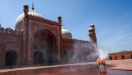 Municipal workers spray disinfectant at the main entrance of the Badshahi mosque ahead of the Muslim holy month of Ramadan during a government-imposed nationwide lockdown as a preventive measure against the COVID-19 coronavirus, in Lahore on April 22, 202