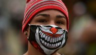 A woman wears a face mask as a preventive measure against the spread of the novel coronavirus, COVID-19, on April 24, 2020, at Santa Elena market in Cali, Colombia. / AFP / Luis ROBAYO