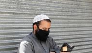 An Afghan man reads the Koran on the first day of the holy fasting month of Ramadan, amid the spread of the coronavirus disease (COVID-19), in Kabul, Afghanistan April 24, 2020. REUTERS/Mohammad Ismail