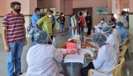 Medical professionals issue modules to members of the media before getting tested for COVID-19 coronavirus as part of an ongoing nationwide screening for media professionals during a government-imposed nationwide lockdown as a preventive measure against t