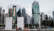 (FILES) In this file photo taken on April 21, 2020, a man sits next to a fountain at the Sun Yat Sen Memorial Park in Hong Kong. As Hong Kongers hunker down during the coronavirus pandemic, police have ramped up arrests of pro-democracy activists while Be