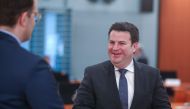 German Labour Minister Hubertus Heil (R) talks with German Health Minister Jens Spahn prior to the weekly cabinet meeting on April 22, 2020 at the Chancelery in Berlin, as the spread of the new coronavirus that can cause the COVID-19 disease continues. / 