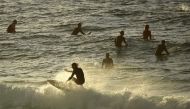 Surfers are seen in the ocean after Bondi Beach reopened following a five week closure in Sydney on April 28, 2020, amid the COVID-19 novel coronavirus pandemic./ AFP / PETER PARKS
